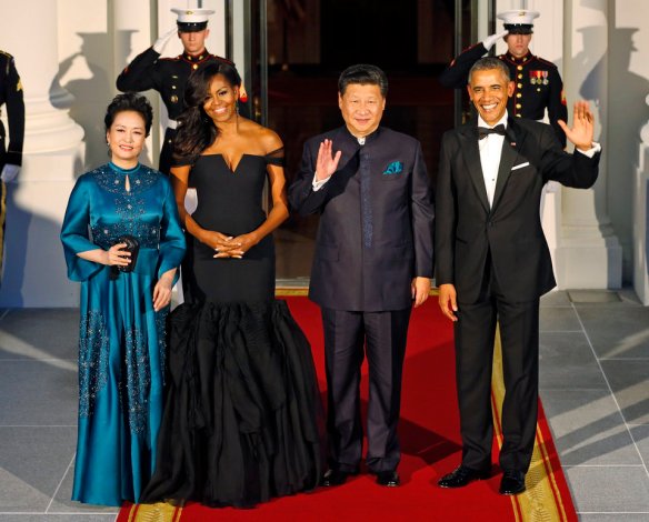 President Barack Obama, right, and Chinese President Xi Jinping, second from right, wave along with, wives Peng Liyuan, left, and first lady Michelle Obama as they arrive for a state dinner at the White House in Washington, Friday, Sept. 25, 2015. (AP Photo/Steve Helber)